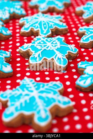 Many snowflake shaped cookies on the red tablecloth. Stock Photo