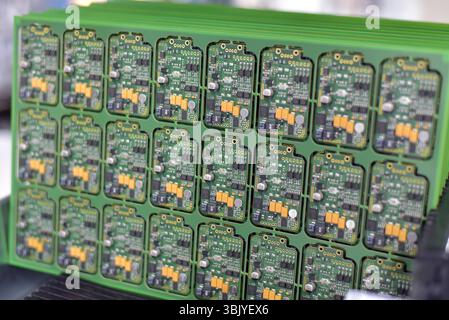 production of microelectronics in a modern industrial factory - motherboard with components in production Stock Photo
