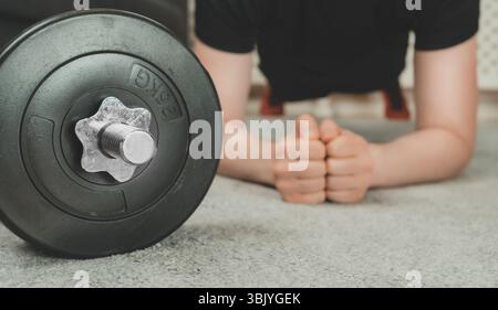 Man doing plank exercise. Home fitness training concept. Stock Photo