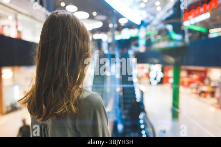 Girl in lift in a large shopping center. Stock Photo