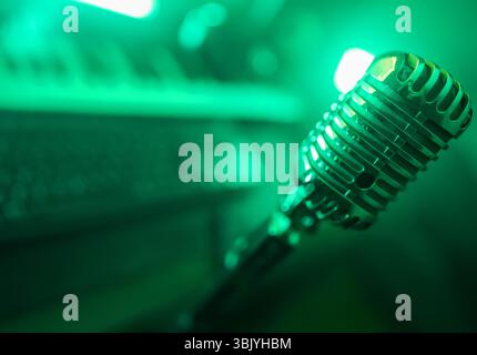 Retro microphone and midi keyboard synthesizer in record studio. Stock Photo