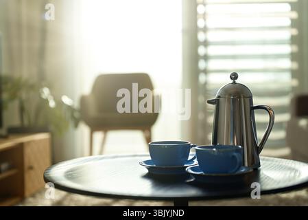 Teapot and two cups on the table in the morning. Stock Photo