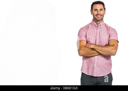 Adult man standing with arms crossing and smiling at camera on seamless white backdrop in studio Stock Photo