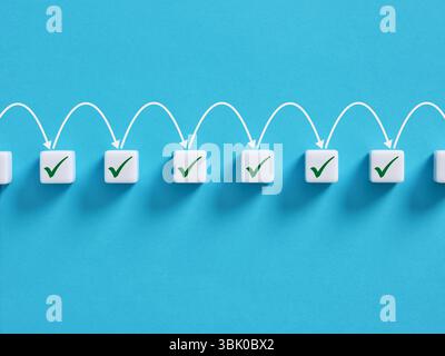 Automated workflow. Accomplishing the necessary tasks or steps. Step by step task completion. White blocks showing check marks with connecting arrows Stock Photo
