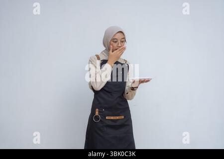 Asian young muslim wearing hijab and black apron Stock Photo
