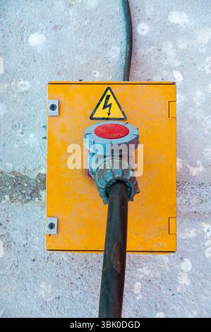 Electrical box with a high-voltage cable connected to it. Stock Photo
