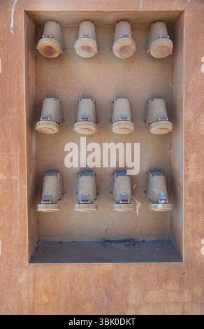Rows of industrial electrical sockets near the switchboard. High voltage port sockets. Stock Photo