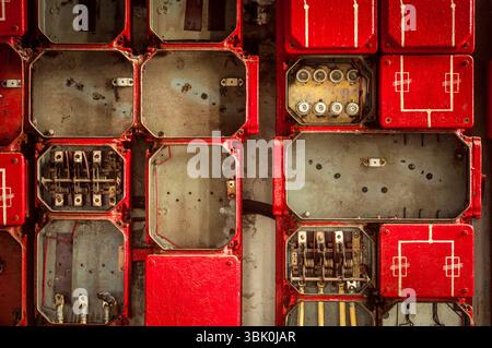 Lot of junction boxes on the wall in dark colors Stock Photo