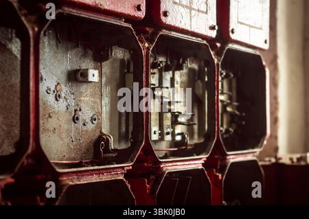 Lot of junction boxes on the wall in dark colors Stock Photo