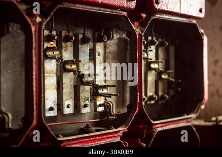 Lot of junction boxes on the wall in dark colors Stock Photo