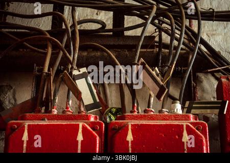 Lot of junction boxes on the wall in dark colors Stock Photo