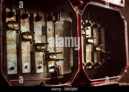 Lot of junction boxes on the wall in dark colors Stock Photo