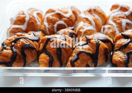 Freshly made white and black chocolate mini croissants on a tray Stock Photo