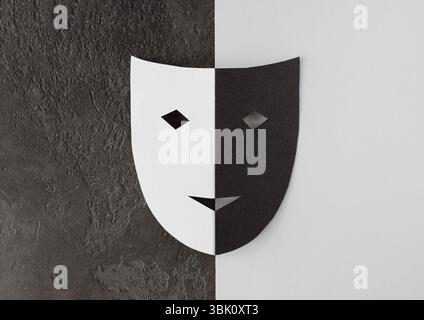 Cardboard theatrical two tone mask on texture background, copy space, minimalistic photo Stock Photo