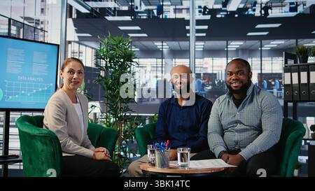 Group of diverse business partners meeting for a new contract negotiation, working together for a global development. Associates analyzing insights and annual reports in a briefing. Camera A. Stock Photo