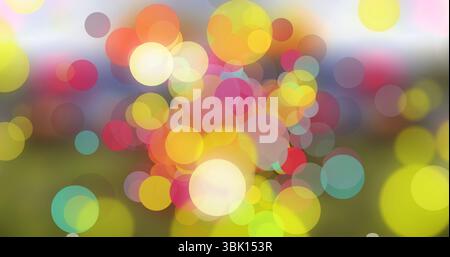 Floating translucent light circles overlapping in open grassy meadow, multicolored light overlays Stock Photo