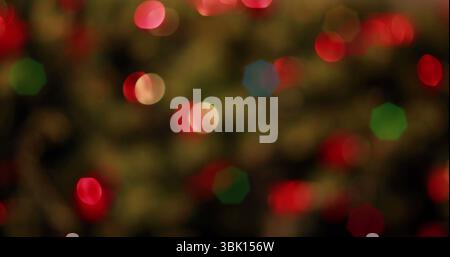 Displaying cluster of blurred colorful bokeh lights in abstract close-up, with string lights Stock Photo
