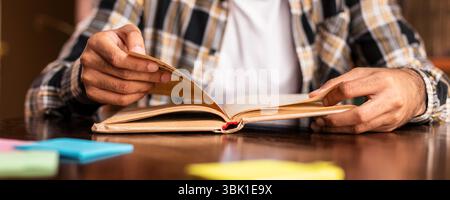 Student Guy Reading Book Learning Sitting In Library Stock Photo