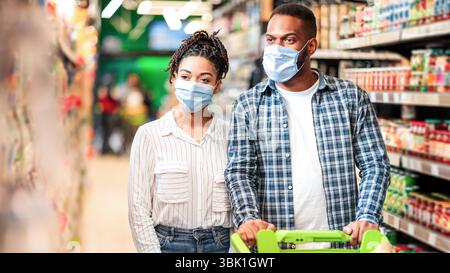 African American Family Couple In Supermarket Walking Buying Food Stock Photo