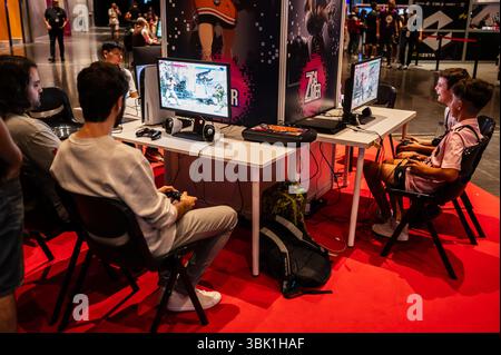 People watching video games at ZGamer, a festival of video games, digital entertainment, board games and YouTubers during El Pilar Fiestas in Zaragoza, Aragon, Spain. Stock Photo