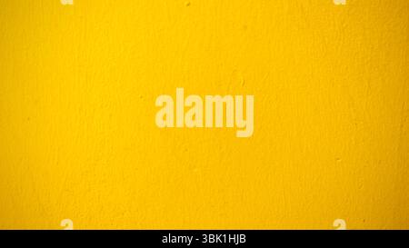 Vibrant Yellow Wall Texture Background Stock Photo