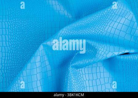 Blue color artificial crocodile leather texture as background. Stock Photo