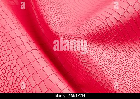 Red color artificial crocodile leather texture as background. Stock Photo