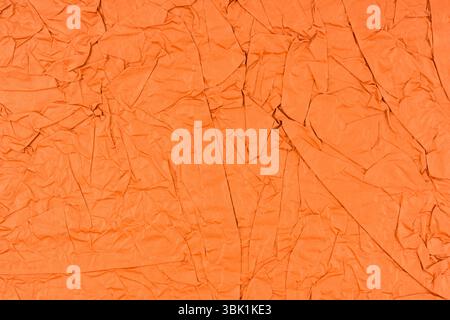 Orange color crumpled paper texture as background. Stock Photo