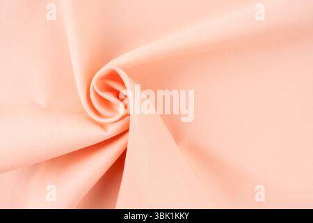 Texture of peach tone color fabric as background, top view. Stock Photo