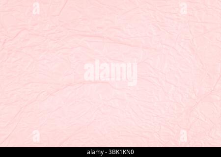 Pink crumpled paper texture as background. Stock Photo