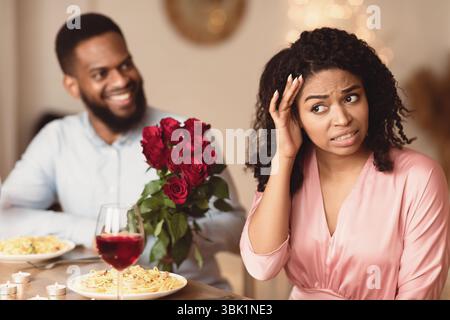 Black Couple On Unsuccessful Blind Date In Restaurant Stock Photo