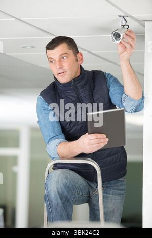 close-up of technician adjusting cctv camera Stock Photo