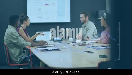 Business team analyzing sales data on chart display in meeting room, with reports and coffee cups Stock Photo