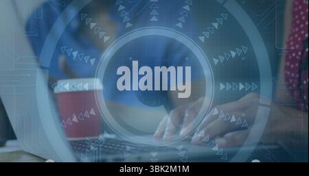 Typing woman in polka dot blouse entering code at wooden office table, with laptop, coffee cup Stock Photo