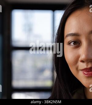 Confident woman in office smiling, focusing on successful business project, copy space Stock Photo