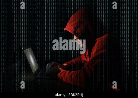 Cyber attack. Hacker working on laptop against black background. Binary code around him Stock Photo