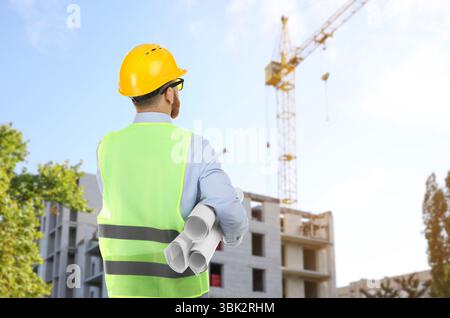 Engineer in safety equipment looking at construction site Stock Photo