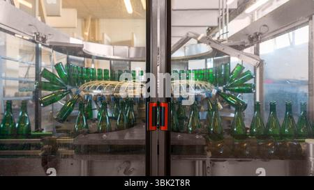 Bottling machine with many bottles in the factory Stock Photo