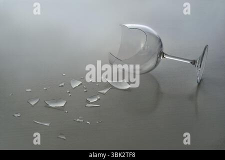 Broken wine glass with shattered fragments Stock Photo