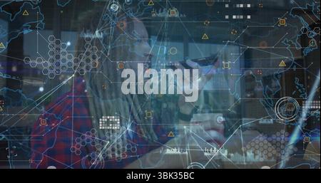 Speaking bearded man with dreadlocks and glasses using smartphone at cafe table, digital network Stock Photo