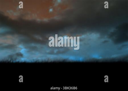 Moody cloudy sky is showing red and blue hues over grass silhouette in flat illustration Stock Photo