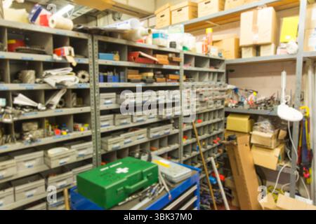 Metal shelving is showcasing labeled bins, tool chest, lamp and first-aid kit in flat design Stock Photo