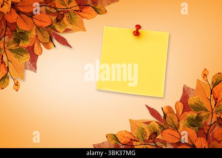Showcasing yellow square sticky note pinned by red thumbtack amid autumn leaves on warm gradient Stock Photo