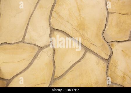 Flat design showing irregular beige flagstone pieces forming paved surface with gray mortar lines Stock Photo