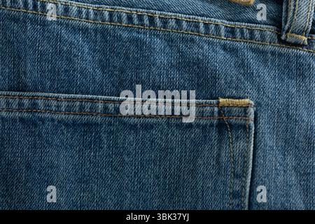 Blue denim jeans back pocket is being shown in 3D render close-up with golden-brown stitching Stock Photo