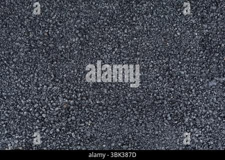 Asphalt road surface is being shown in flat design highlighting dark gray rough stone texture Stock Photo