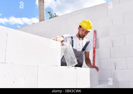 profession construction worker - work on a building site construction of a residential house Stock Photo