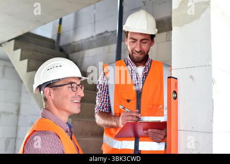 teamwork on the construction site - site manager and architect on site during the construction of a house Stock Photo