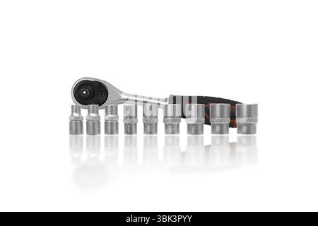 Socket Wrench Set or Ratchet Tools Set, A complete set of silver socket wrenches and a ratchet are arranged on a white background. Stock Photo