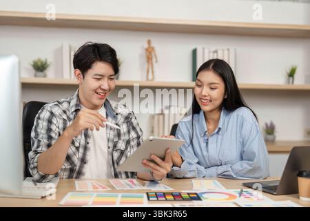 UX and UI Design Engagement. Young professionals reviewing design concepts and color choices in a collaborative environment. Stock Photo